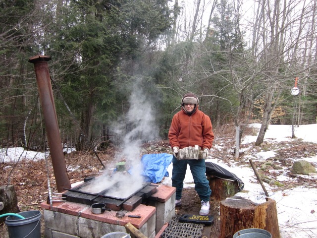 Eileen added wood to a backyard sugaring operation. Photo by Jelane A. Kennedy
